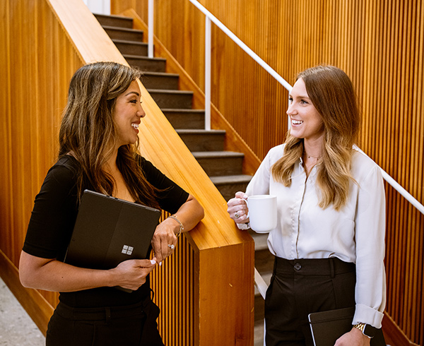 Two business women chat in the Karlin real estate offices