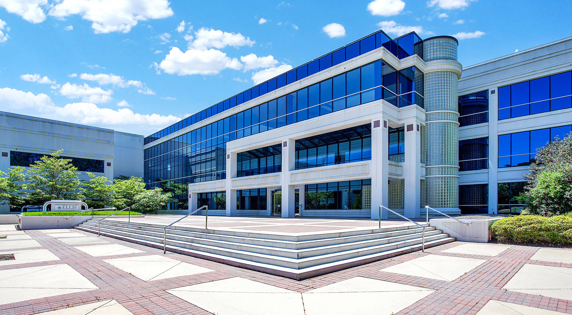 Front view of a modern office building at Parmer RTP with reflective blue windows