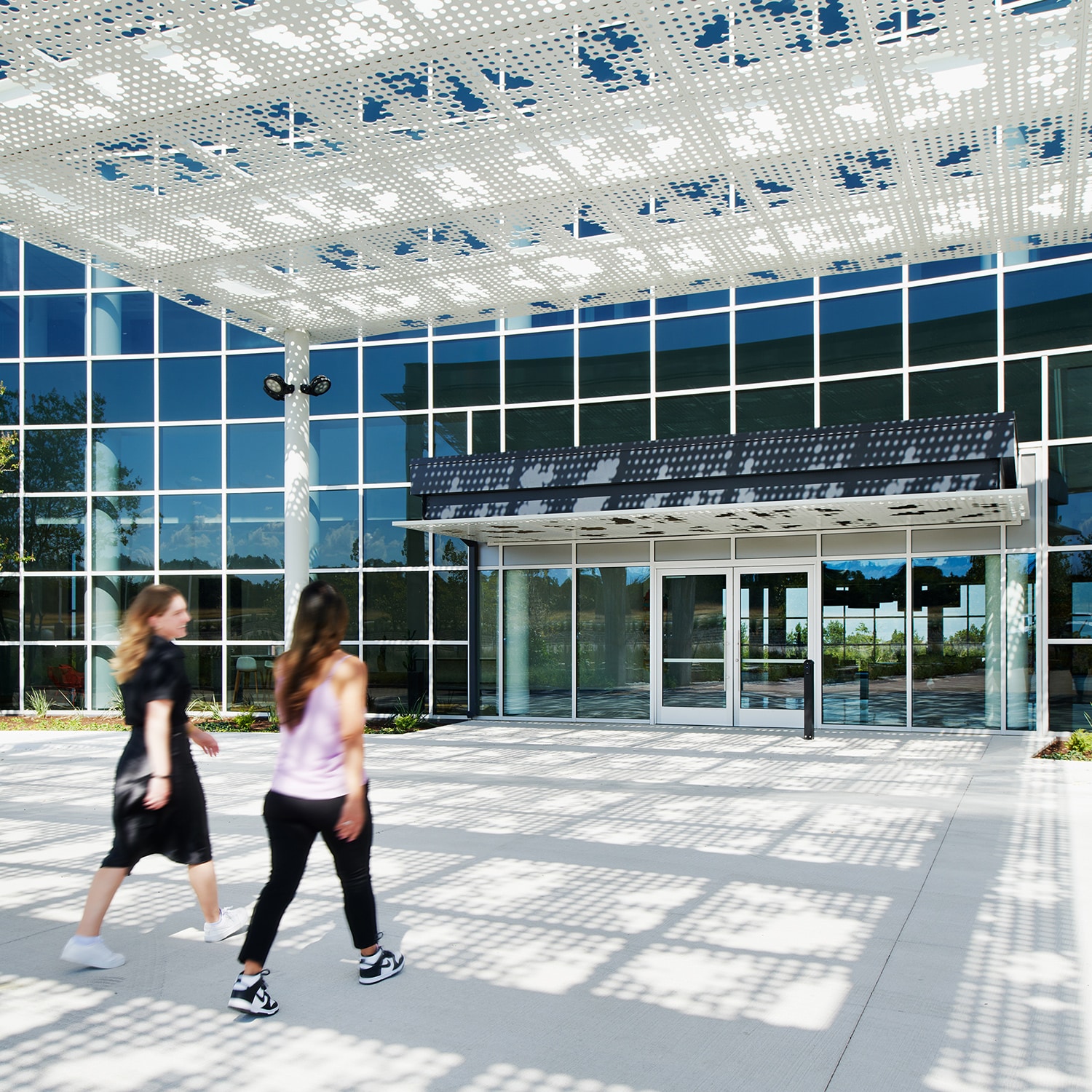 Two women walk into the entrance to Highpoint, a new Karlin development in Austin, TX