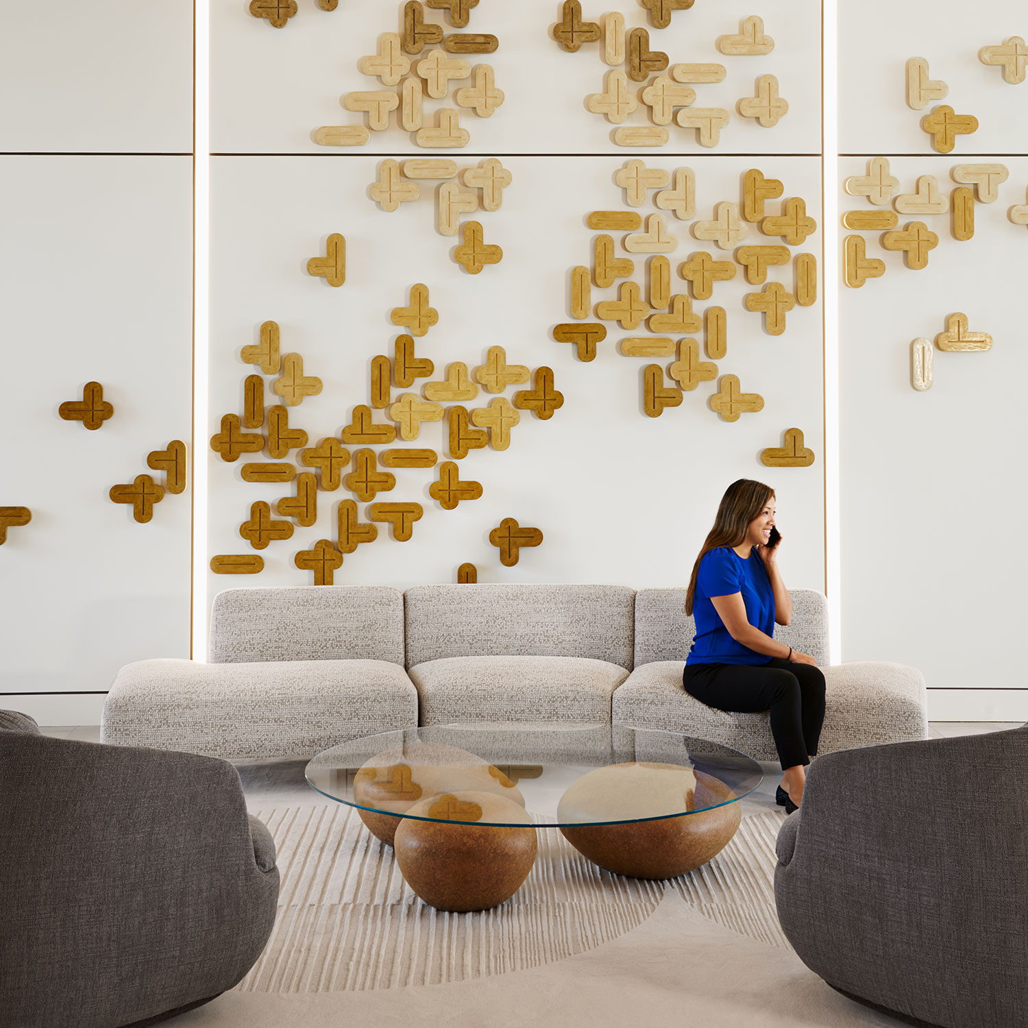 A woman takes a phone call in the seating area at Parmer 2, a development in Austin