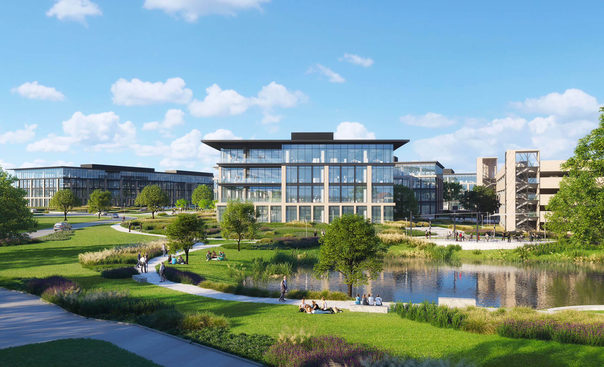 People enjoying a picnic by the pond at Duval office park, surrounded by sleek architecture