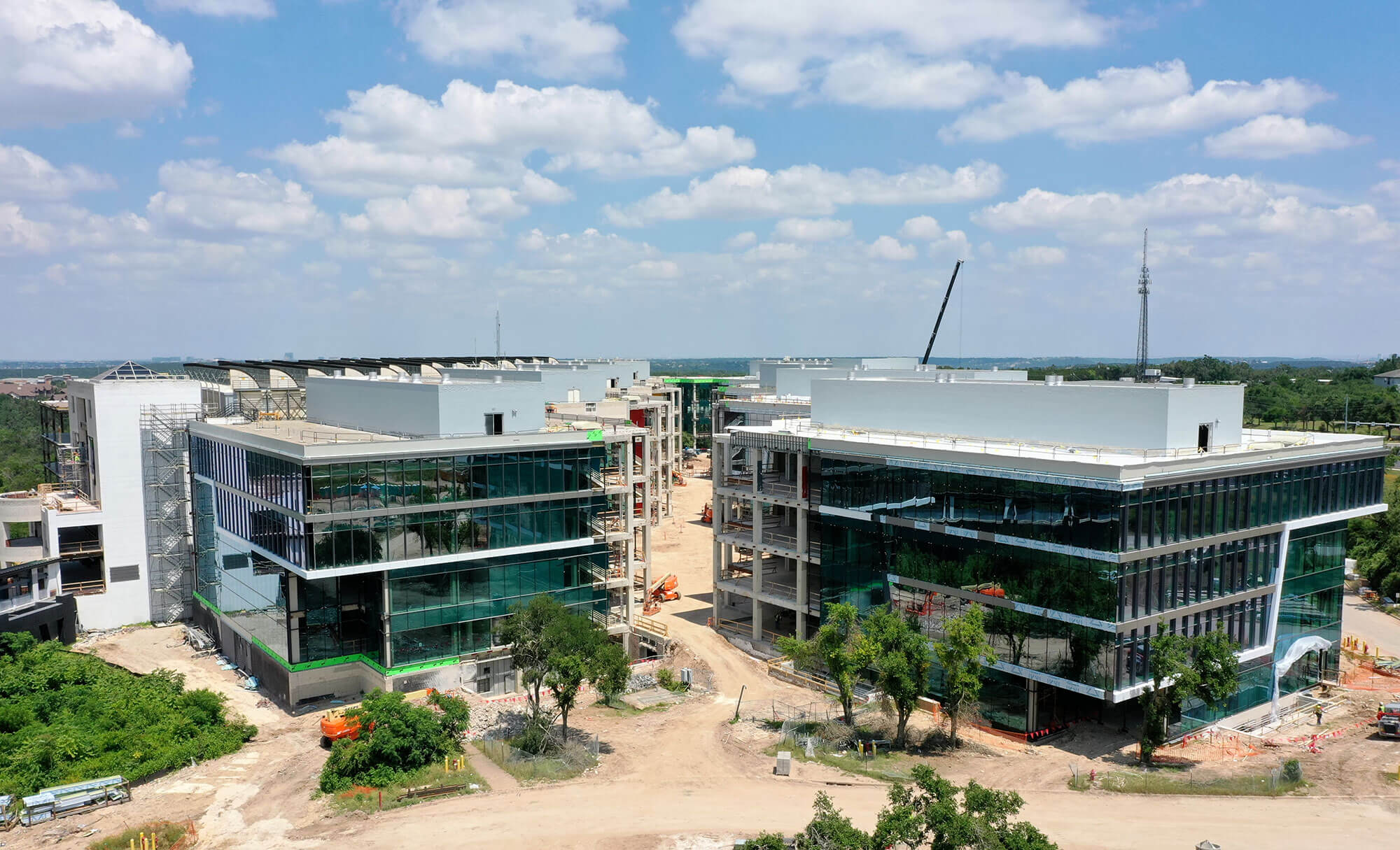 Ongoing construction of Highpoint's modern office complex with cranes and scaffolding