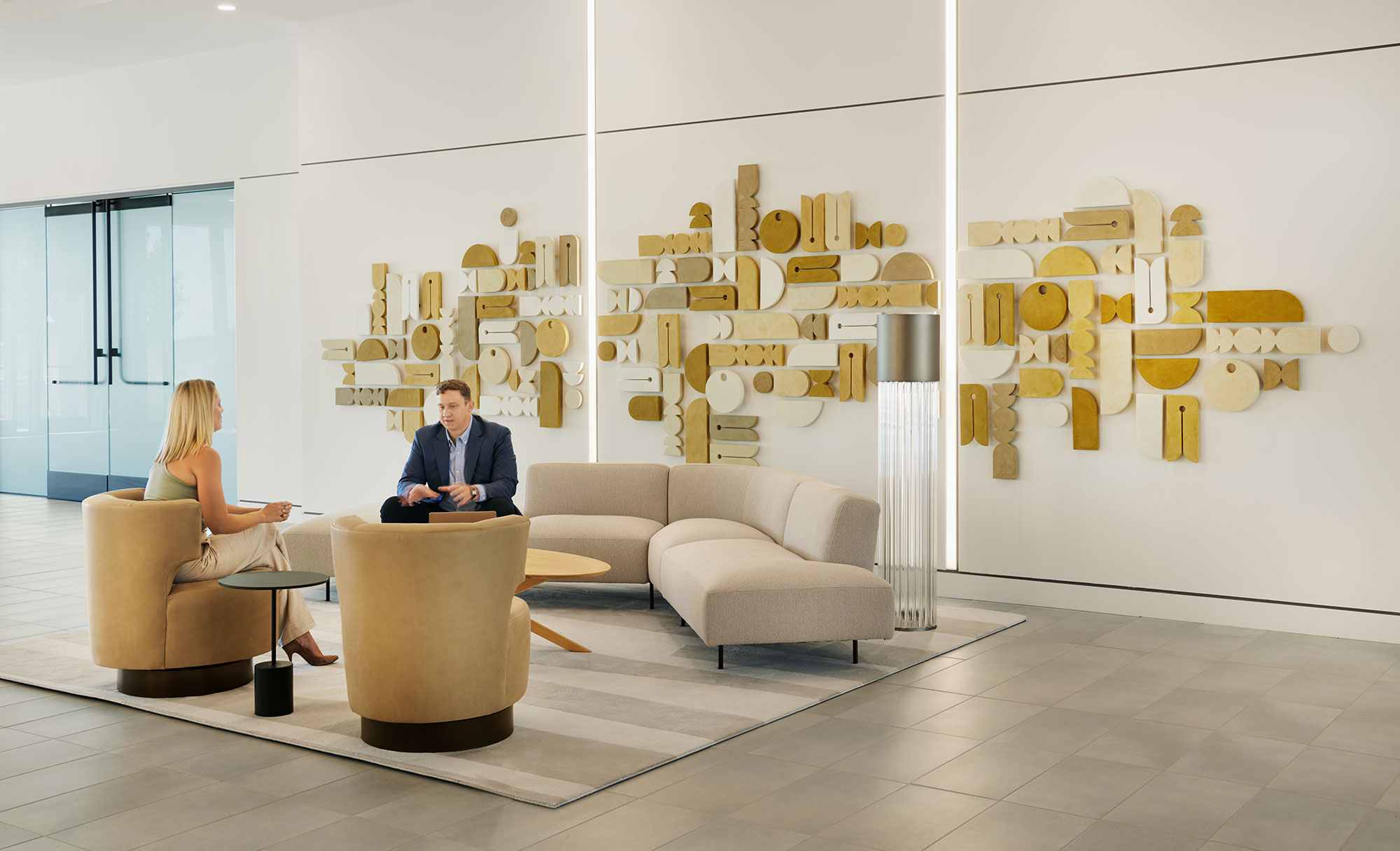 Two people sit in the lobby at Parmer 2, a development in Austin