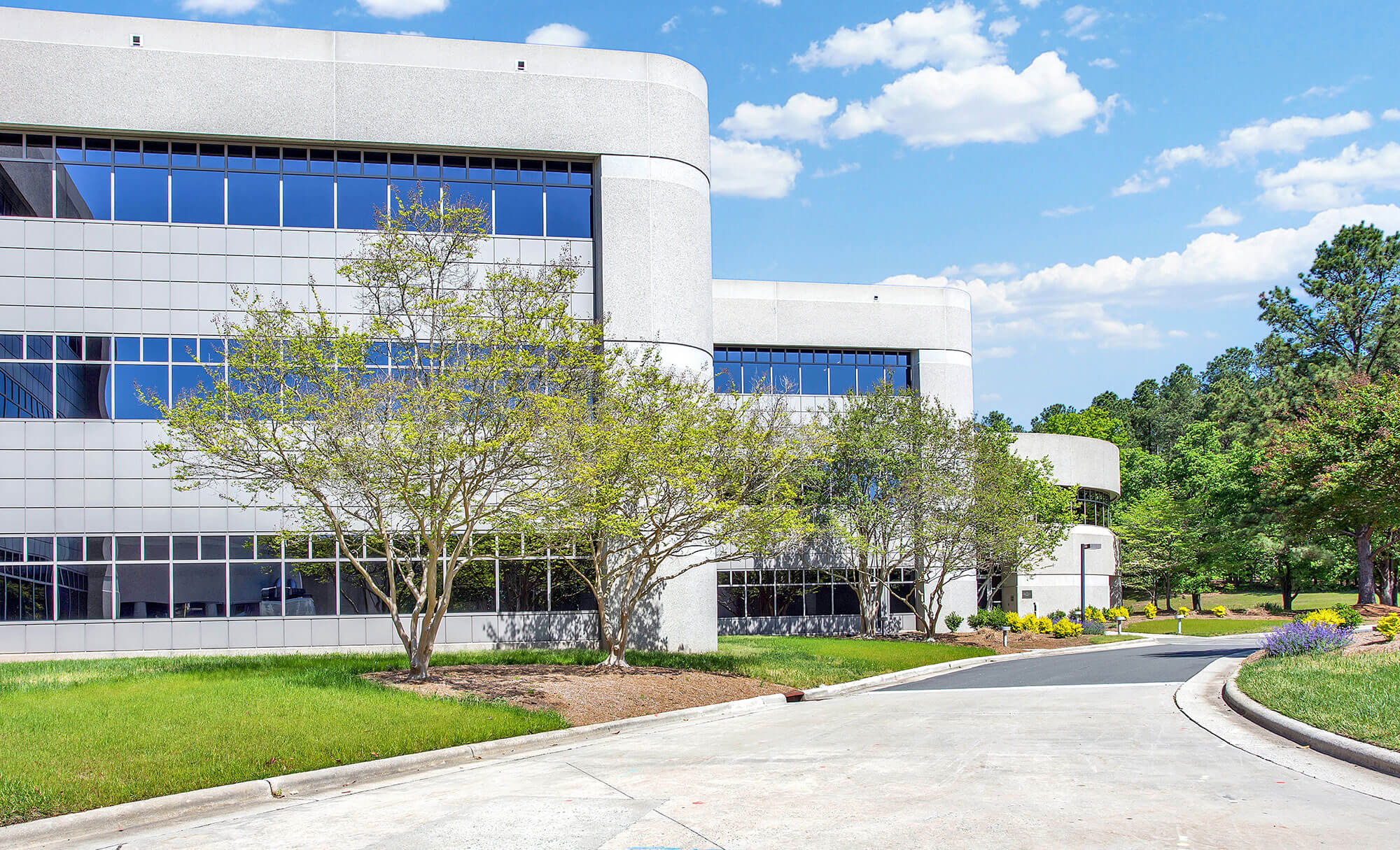 Exterior view of Parmer RTP office building with curved architecture and green landscaping