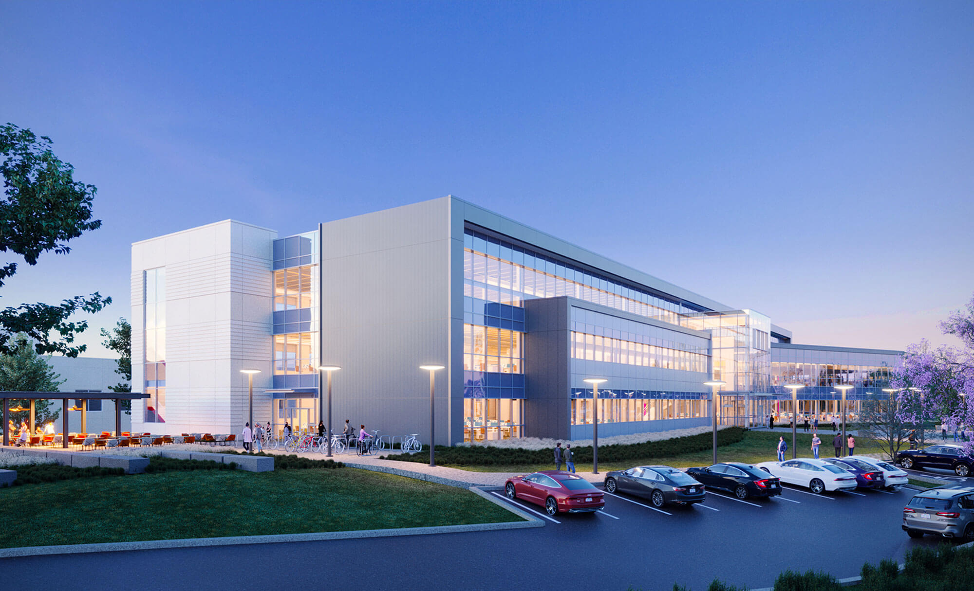 Main entrance of Parmer Woodlands complex featuring glass walls and landscaped parking area