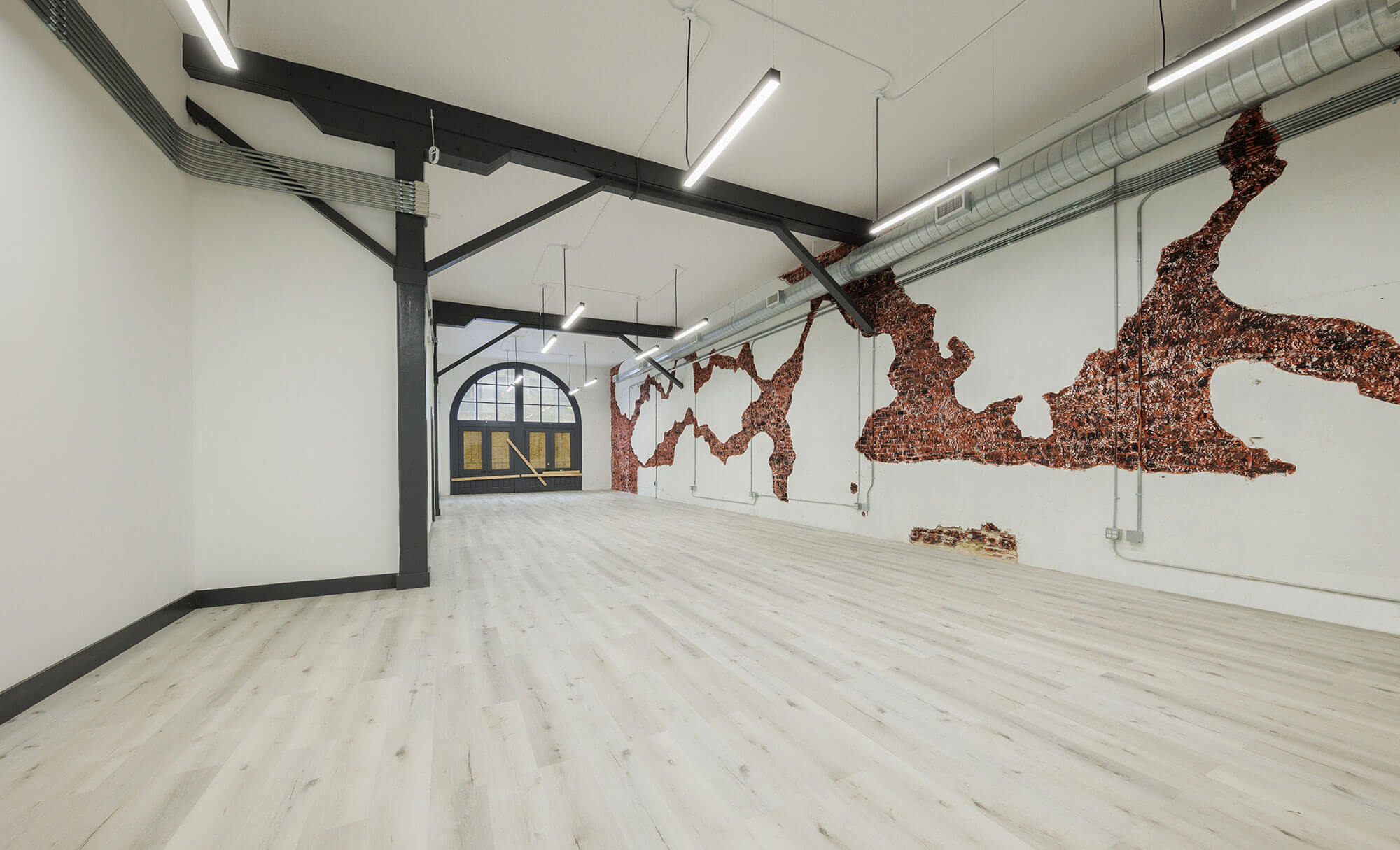 Interior view of Phillips Building office with hardwood floors and industrial design elements