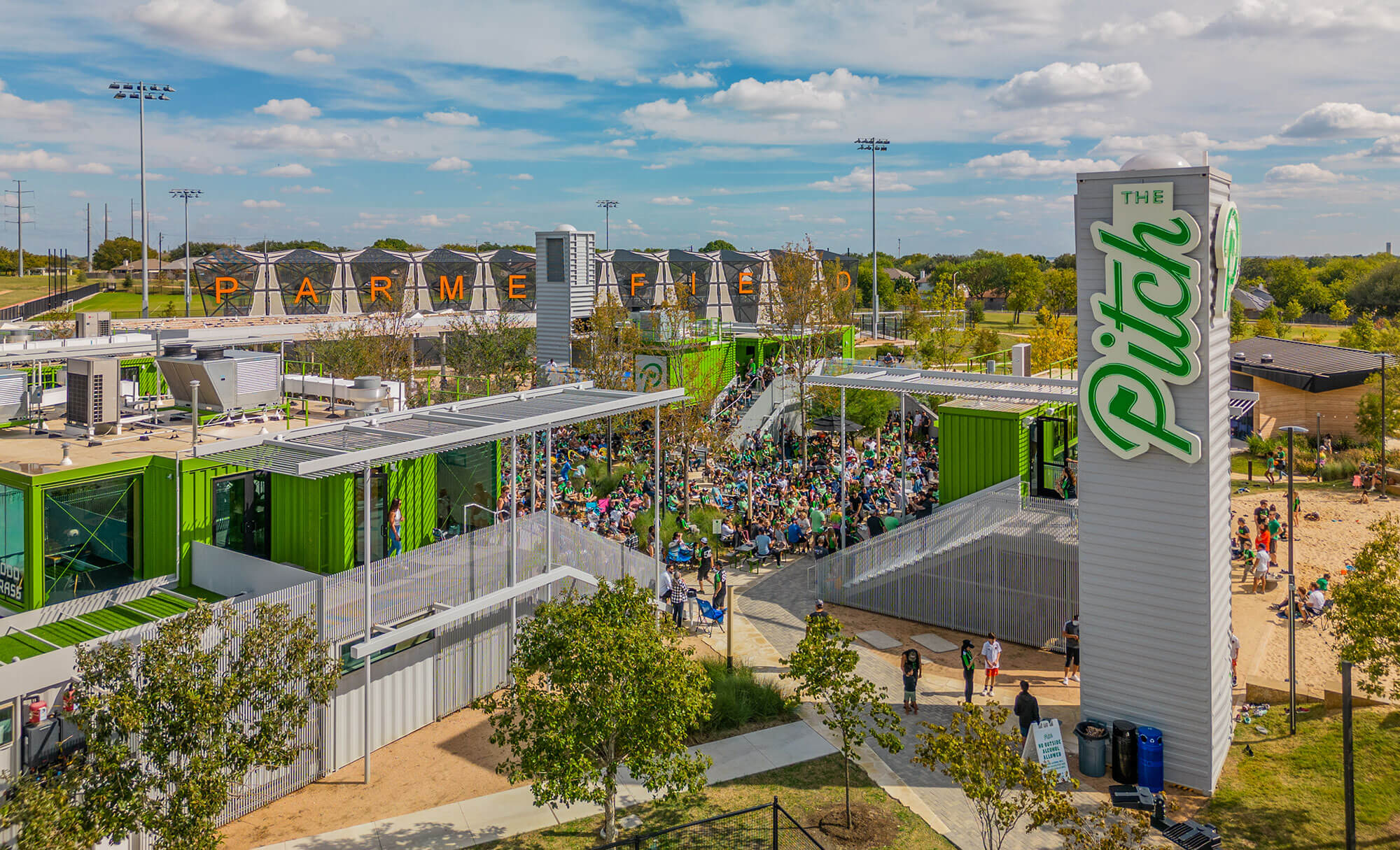 The Pitch's community area with numerous visitors enjoying the facilities and open-air environment