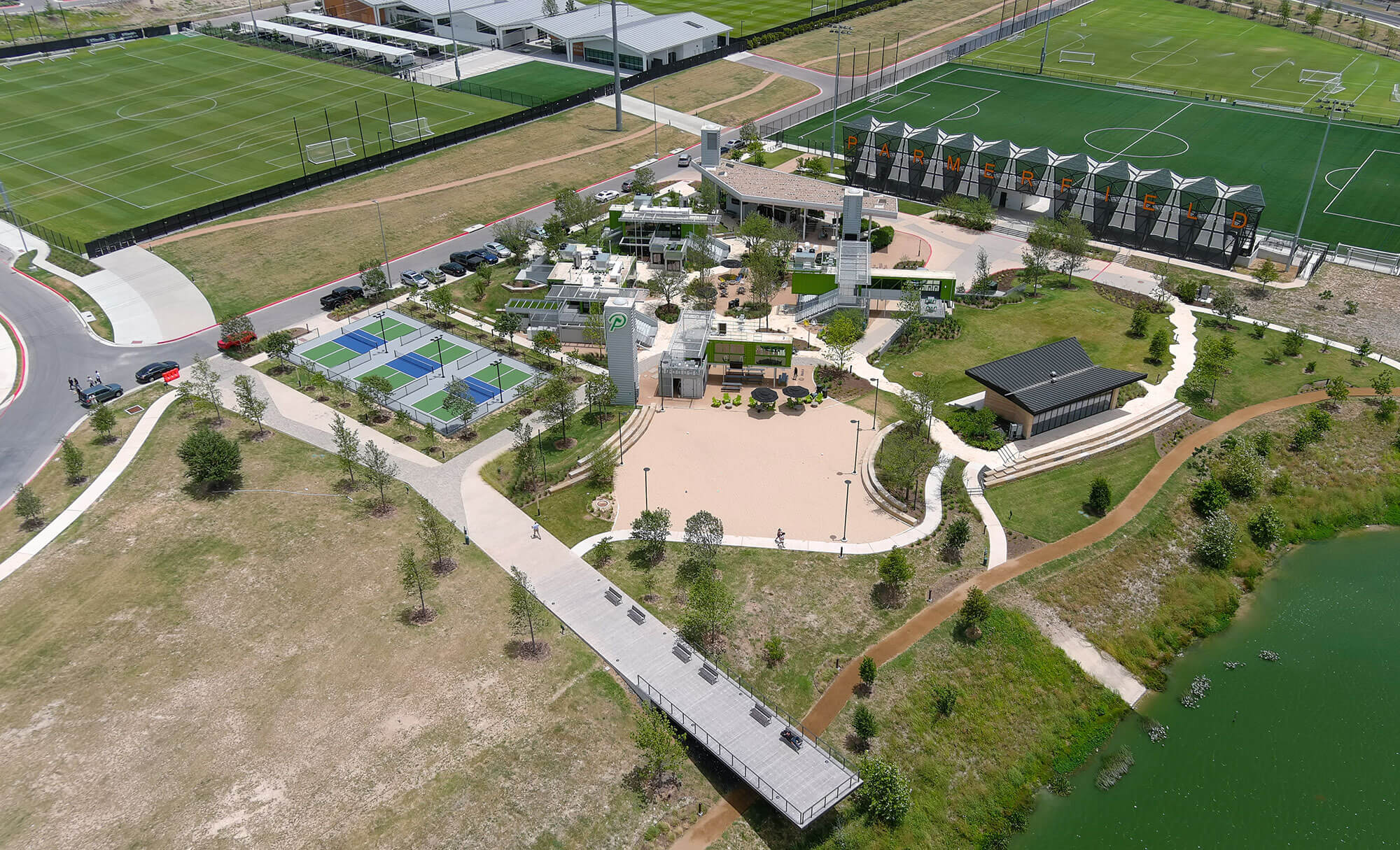 The Pitch's aerial view showing sports facilities, event areas, and a surrounding green landscape