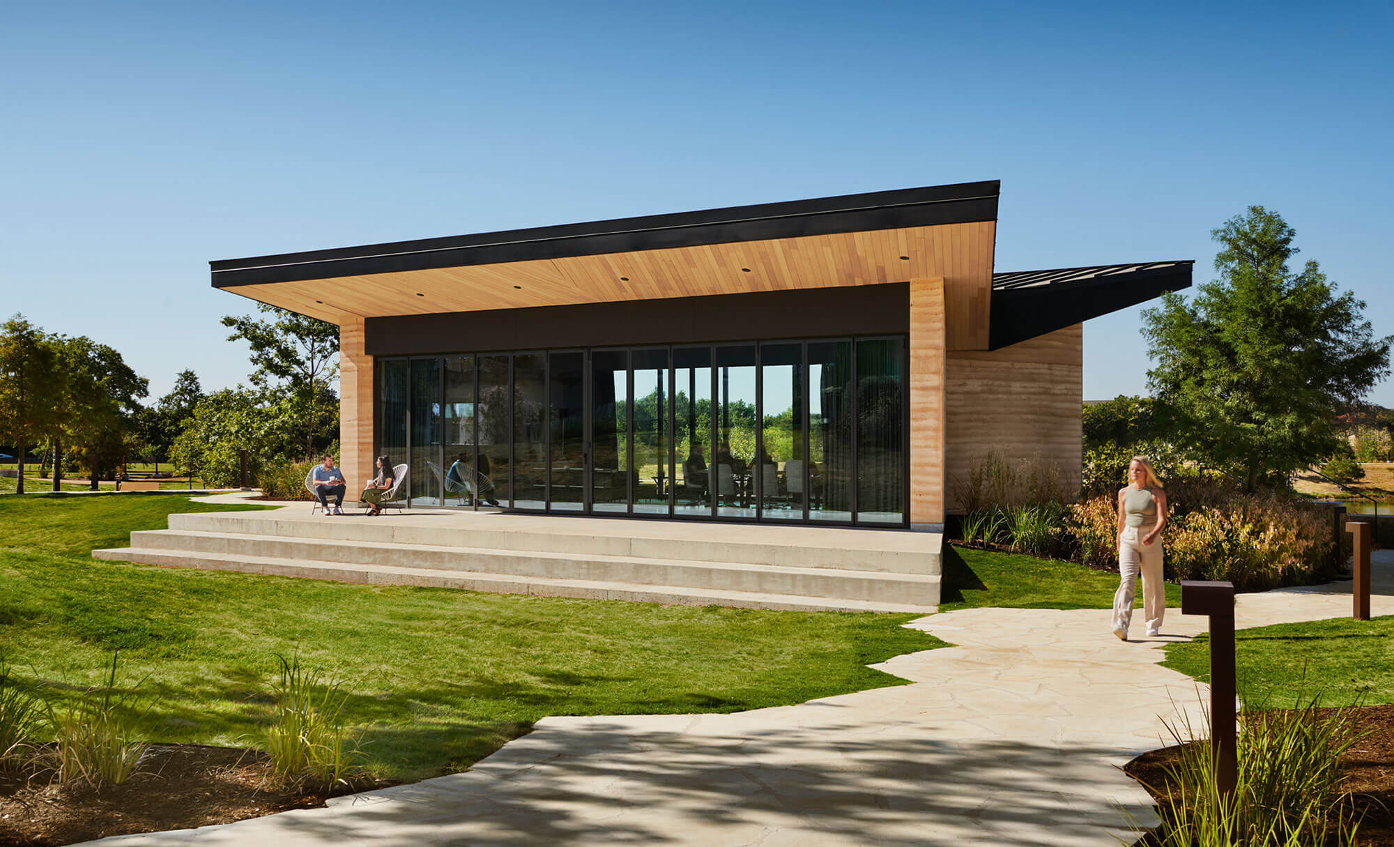 Contemporary design of The Pitch's building, with lush outdoor areas and seating for visitors